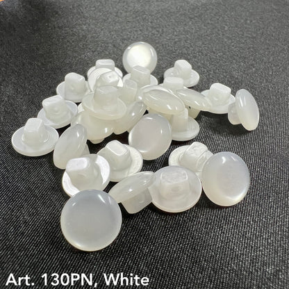White buttons from Buttonology Inc for button sewing supplies on dark fabric background