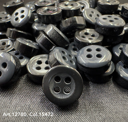 Black and gray four-hole buttons close-up from Buttonology quality button supply collection