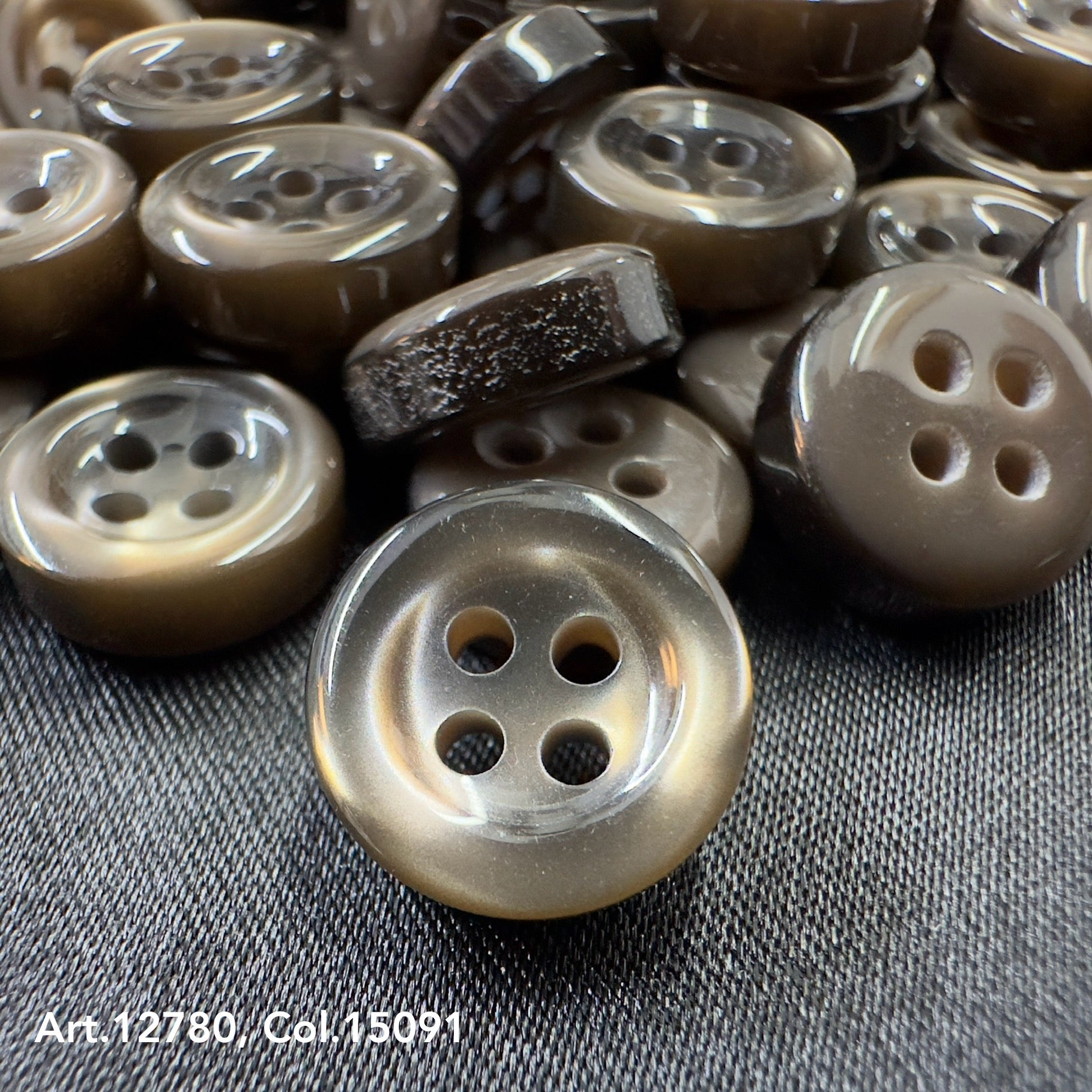 Close-up of brown four-hole buttons providing Buttonology quality button supply for sewing projects