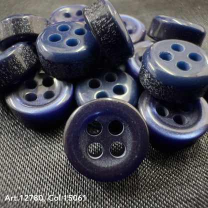 Close-up of blue buttons with four holes showcasing Buttonology quality button supply from Buttonology Inc