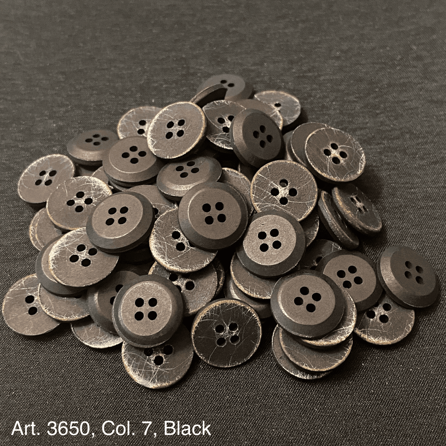 Assorted black buttons for shirts and blouses with a classic four-hole design from Buttonology Inc.