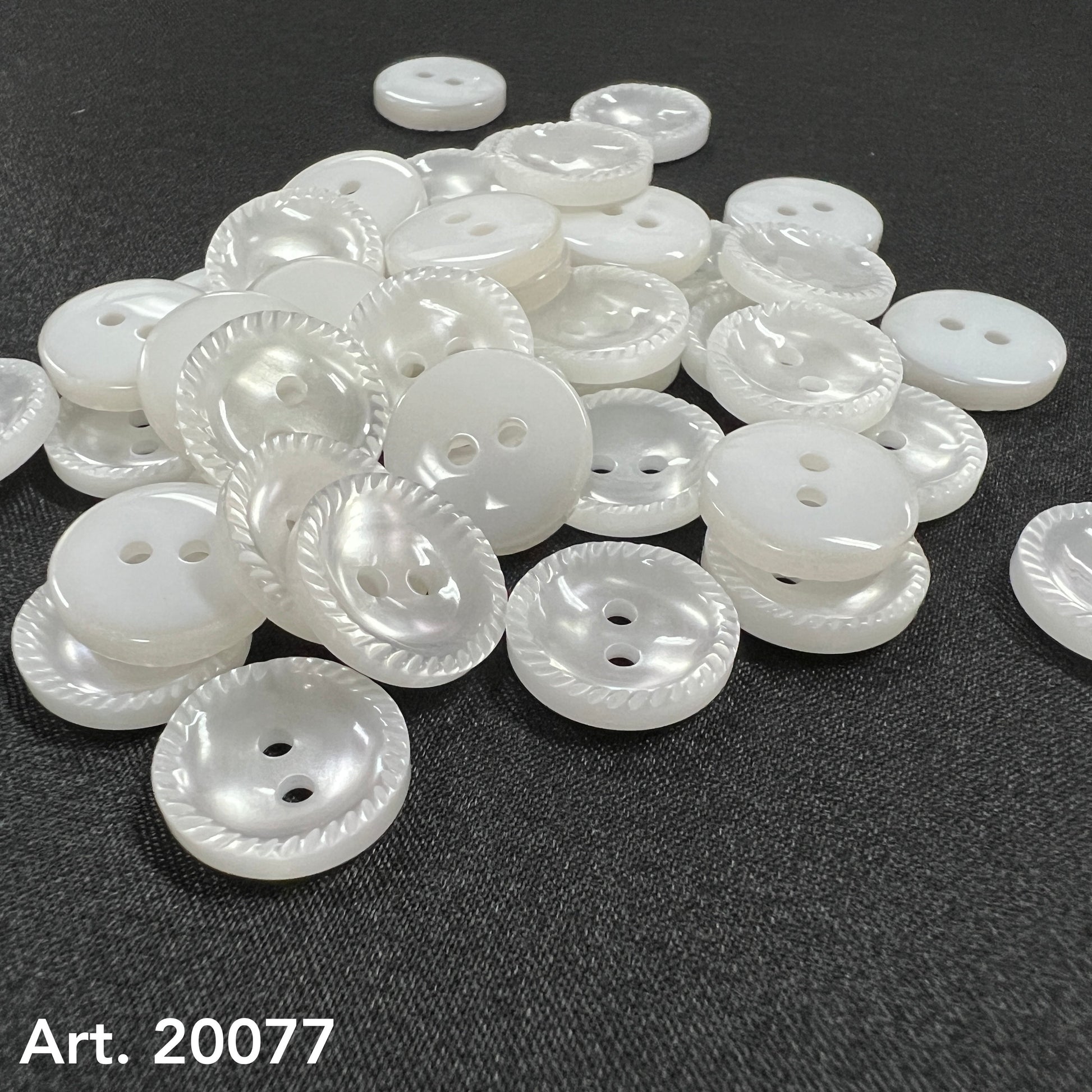 White pearlized two hole buttons with rope edge on dark fabric by Buttonology Inc sew-on buttons for shirts