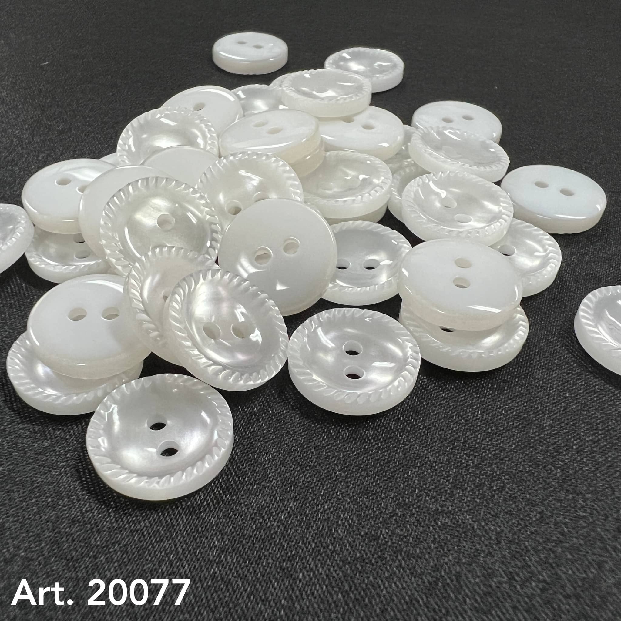 White pearlized two hole buttons with rope edge on dark fabric by Buttonology Inc sew-on buttons for shirts