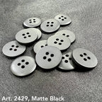 Matte black sewing buttons with four holes from Buttonology Inc to buy sewing buttons online