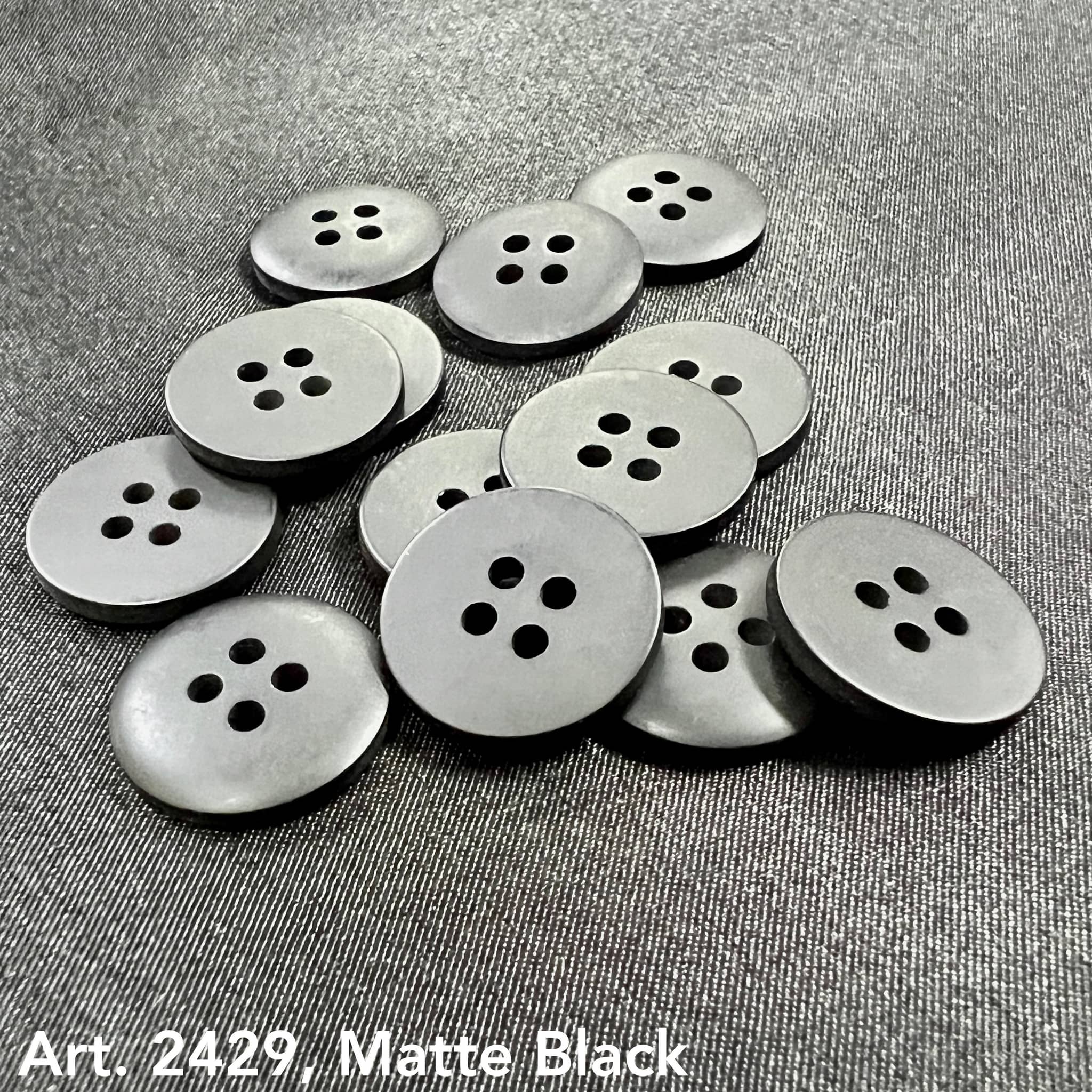 Matte black sewing buttons with four holes from Buttonology Inc to buy sewing buttons online