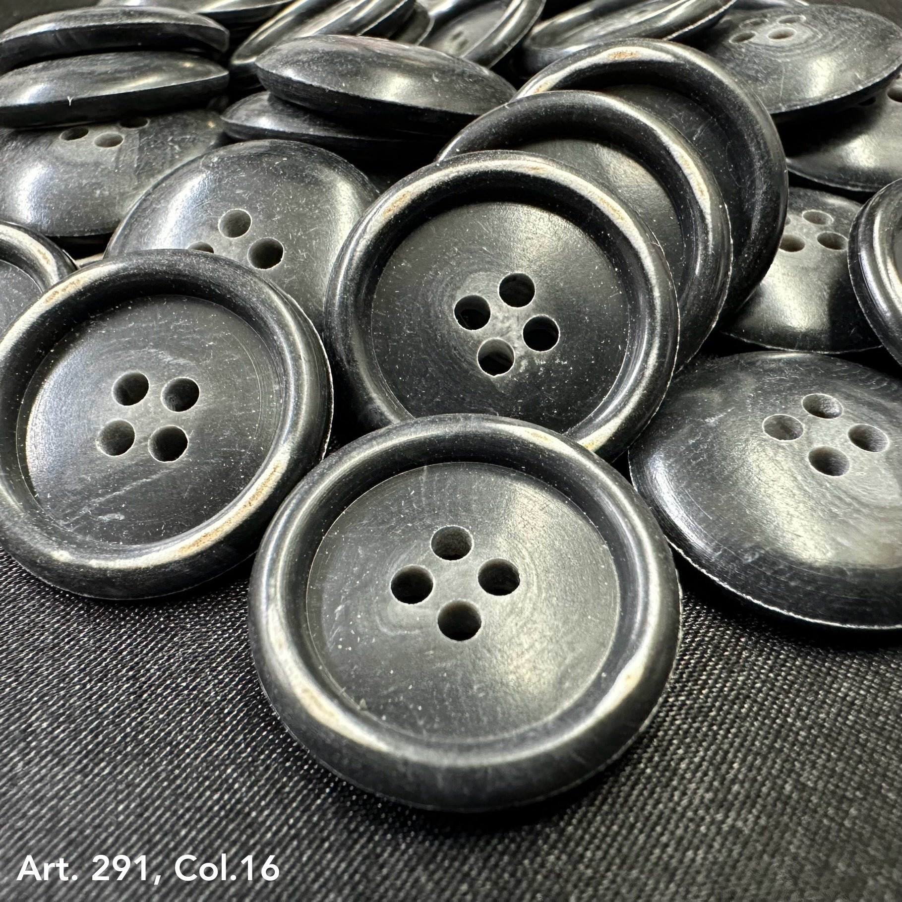 Black coat buttons for sewing with four holes, perfect for garment crafting and repairs