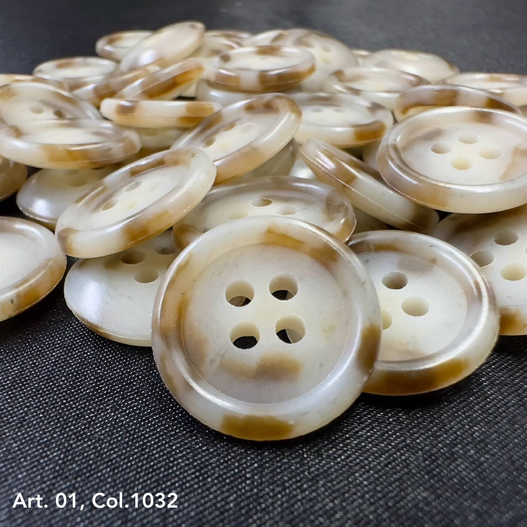 Assorted coat buttons for sewing in cream and brown with four holes, ideal for garment projects.