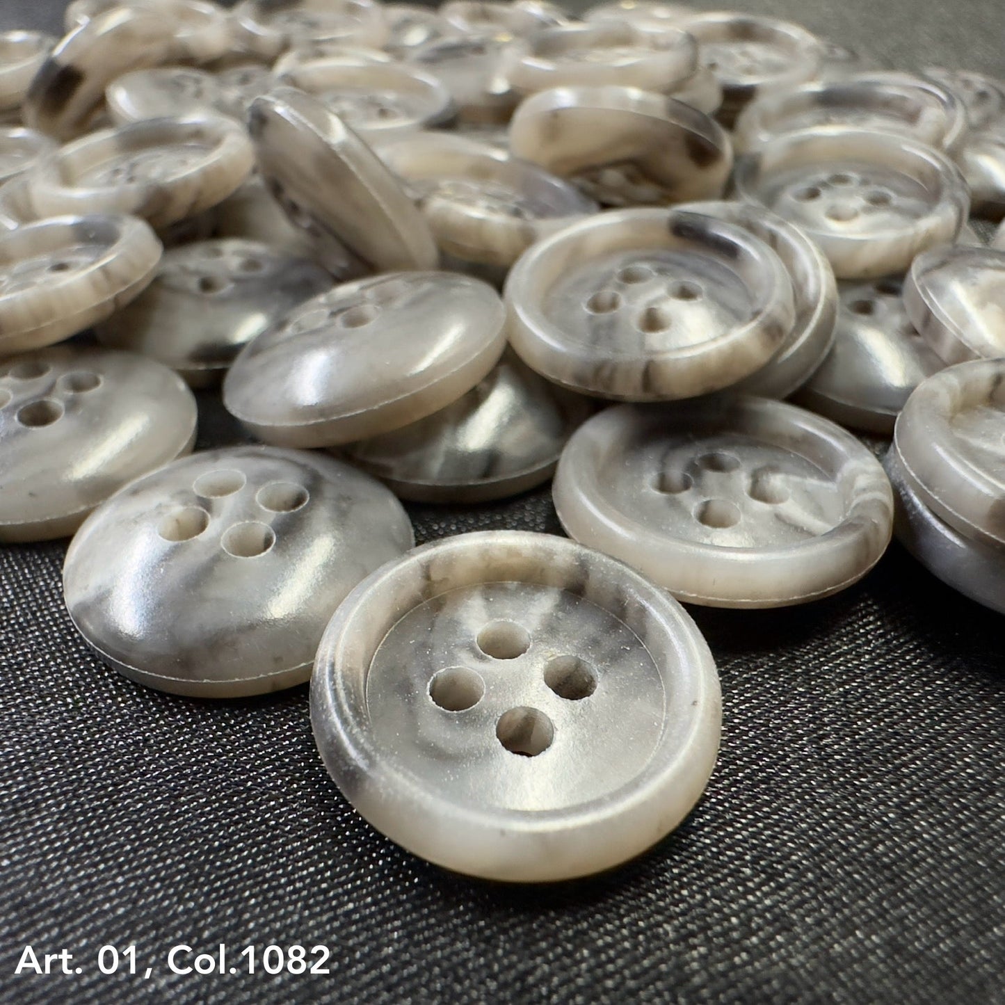 Coat buttons for sewing in a variety of neutral tones with four holes for easy attachment