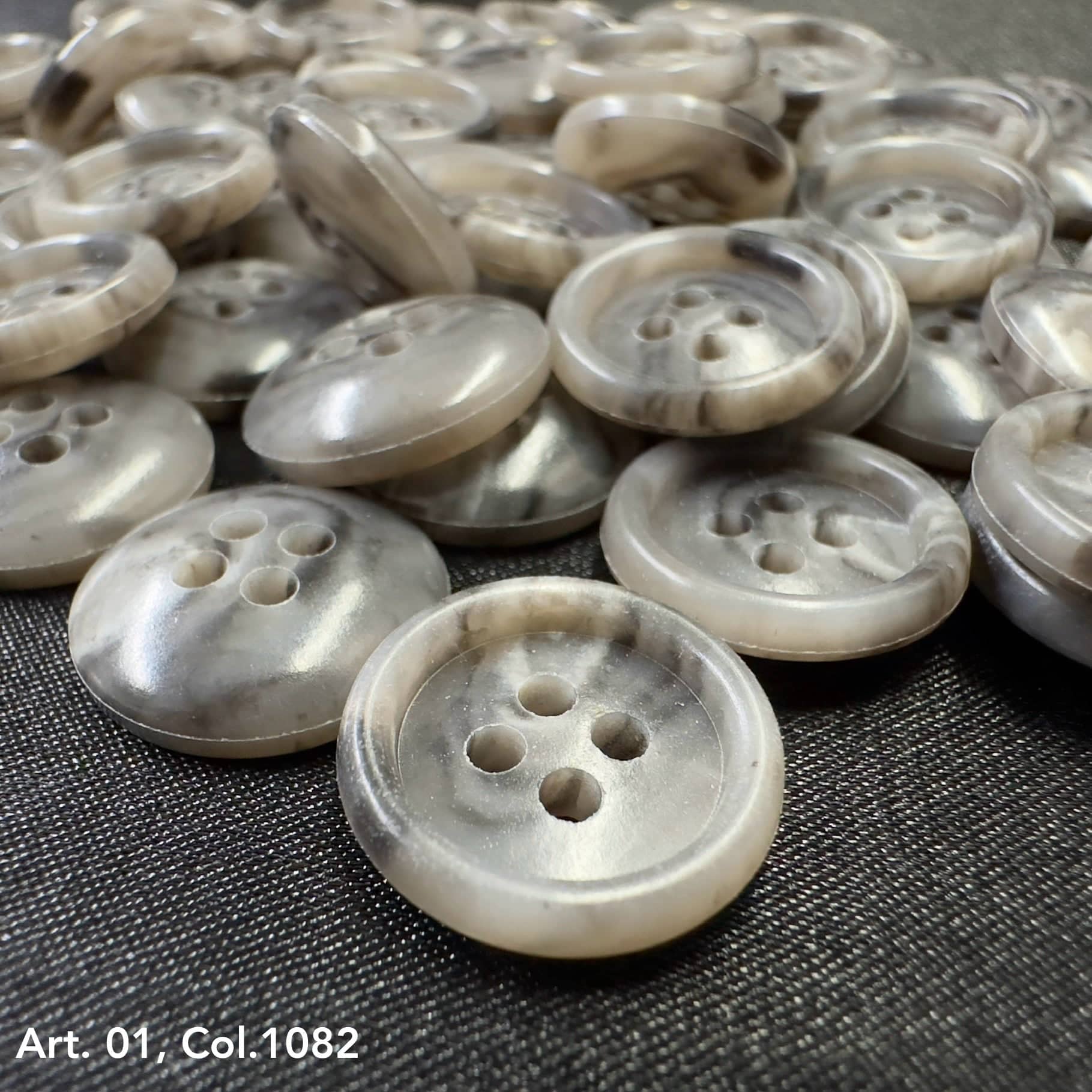 Coat buttons for sewing in a variety of neutral tones with four holes for easy attachment