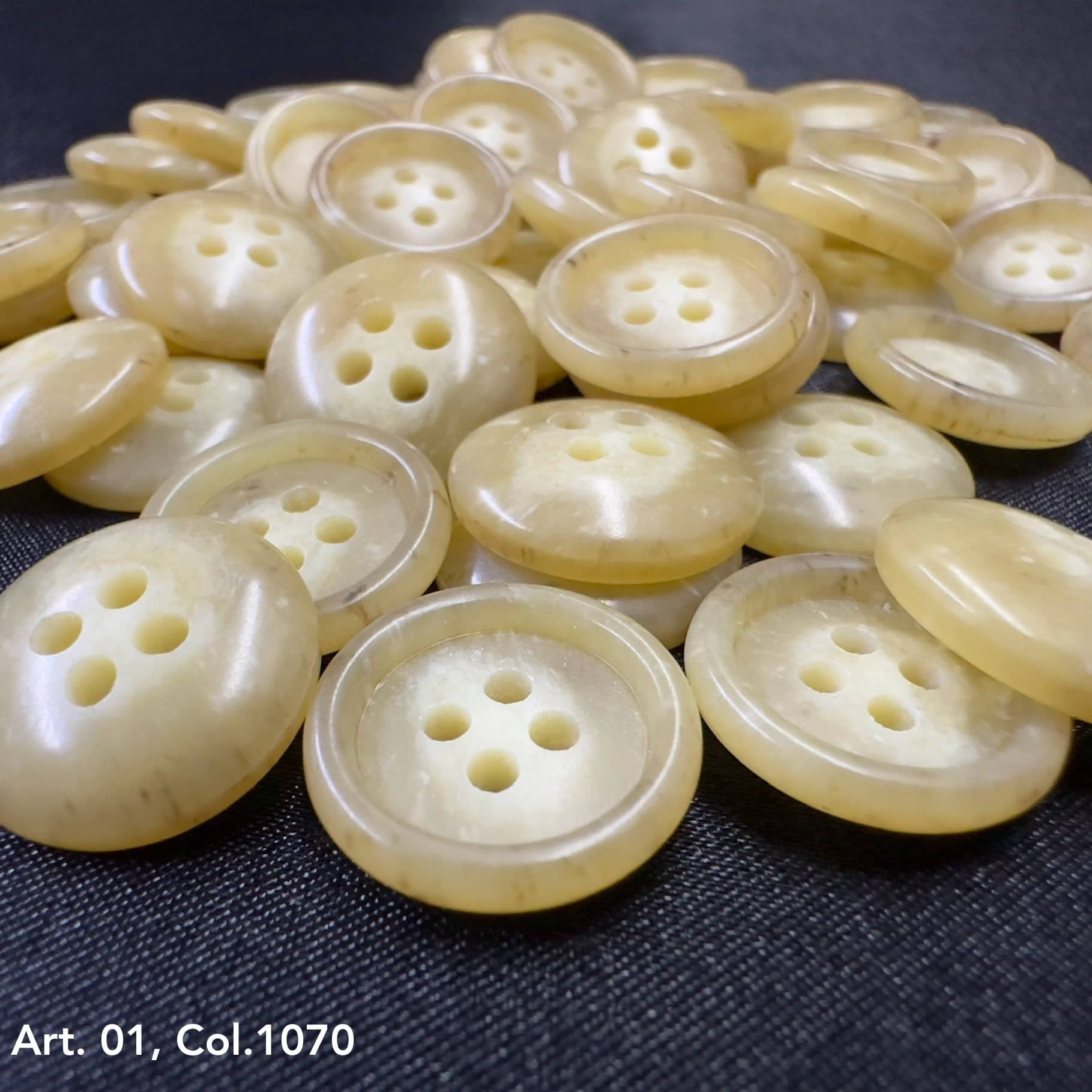 Collection of smooth yellow coat buttons for sewing with four holes each, ideal for garment projects