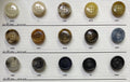 Variety of coat buttons for sewing displayed on a swatch board from Buttonology Inc.