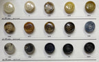 Variety of coat buttons for sewing displayed on a swatch board from Buttonology Inc.