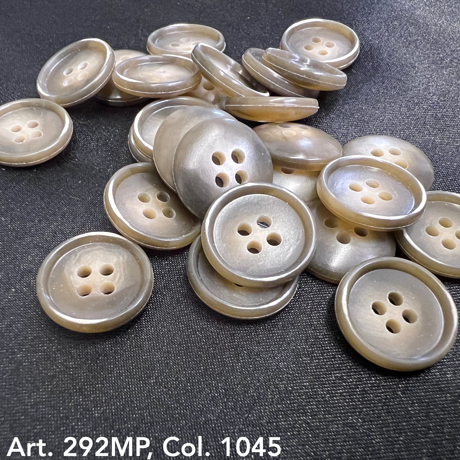 Assorted coat sizing buttons in light brown with four holes for garment fastening by Buttonology Inc.