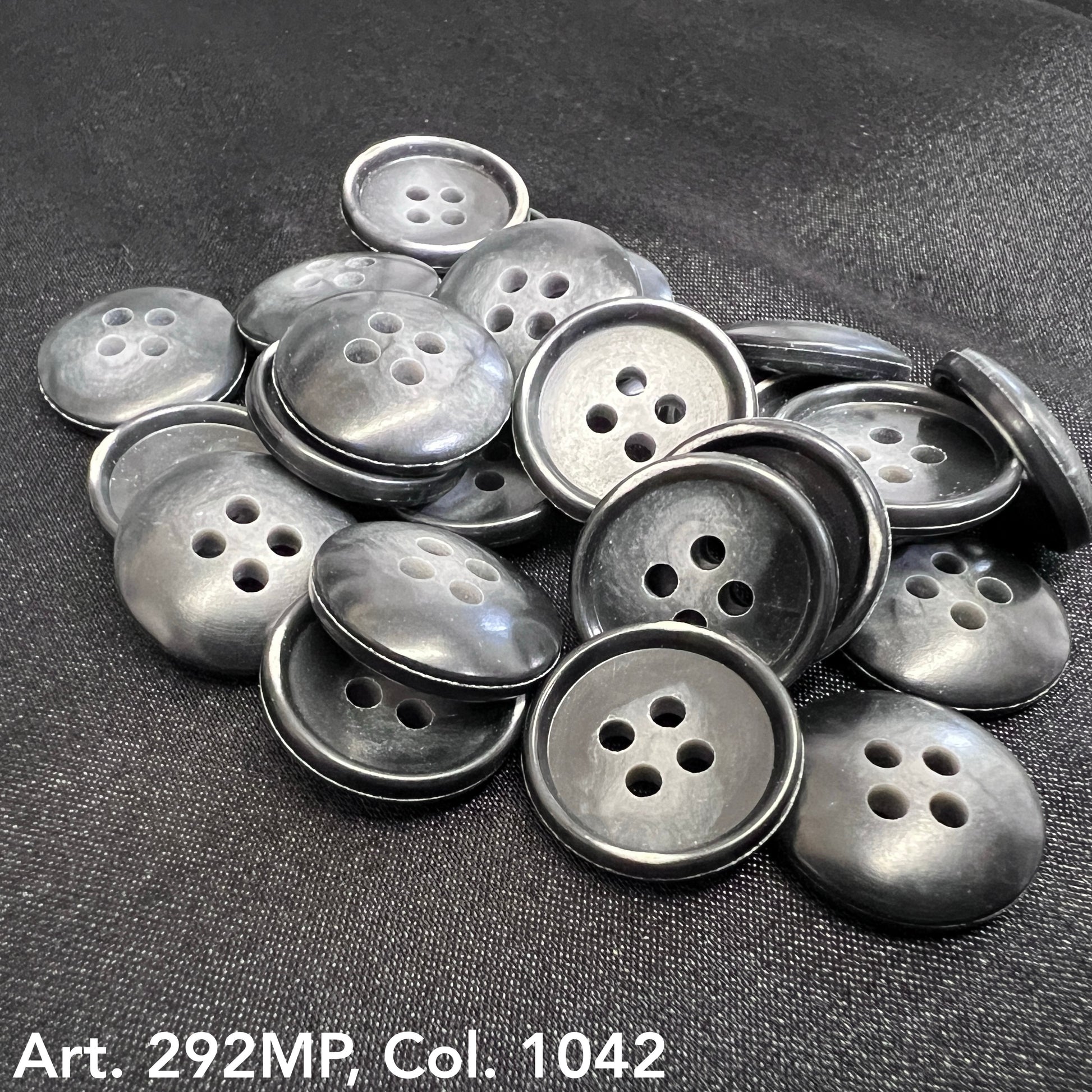 Coat sizing buttons in black by Buttonology Inc arranged on a surface for easy selection