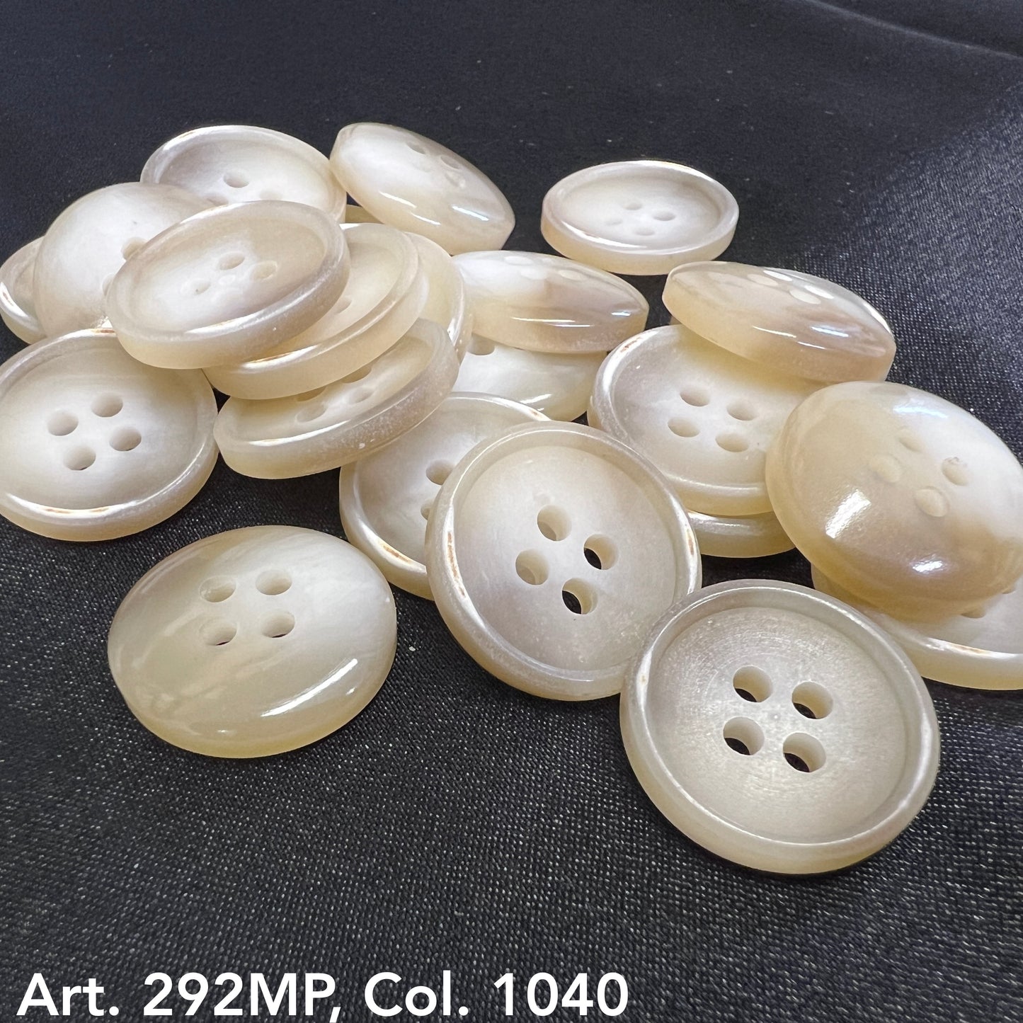 Natural four-hole coat sizing buttons in cream color from Buttonology Inc for tailoring projects