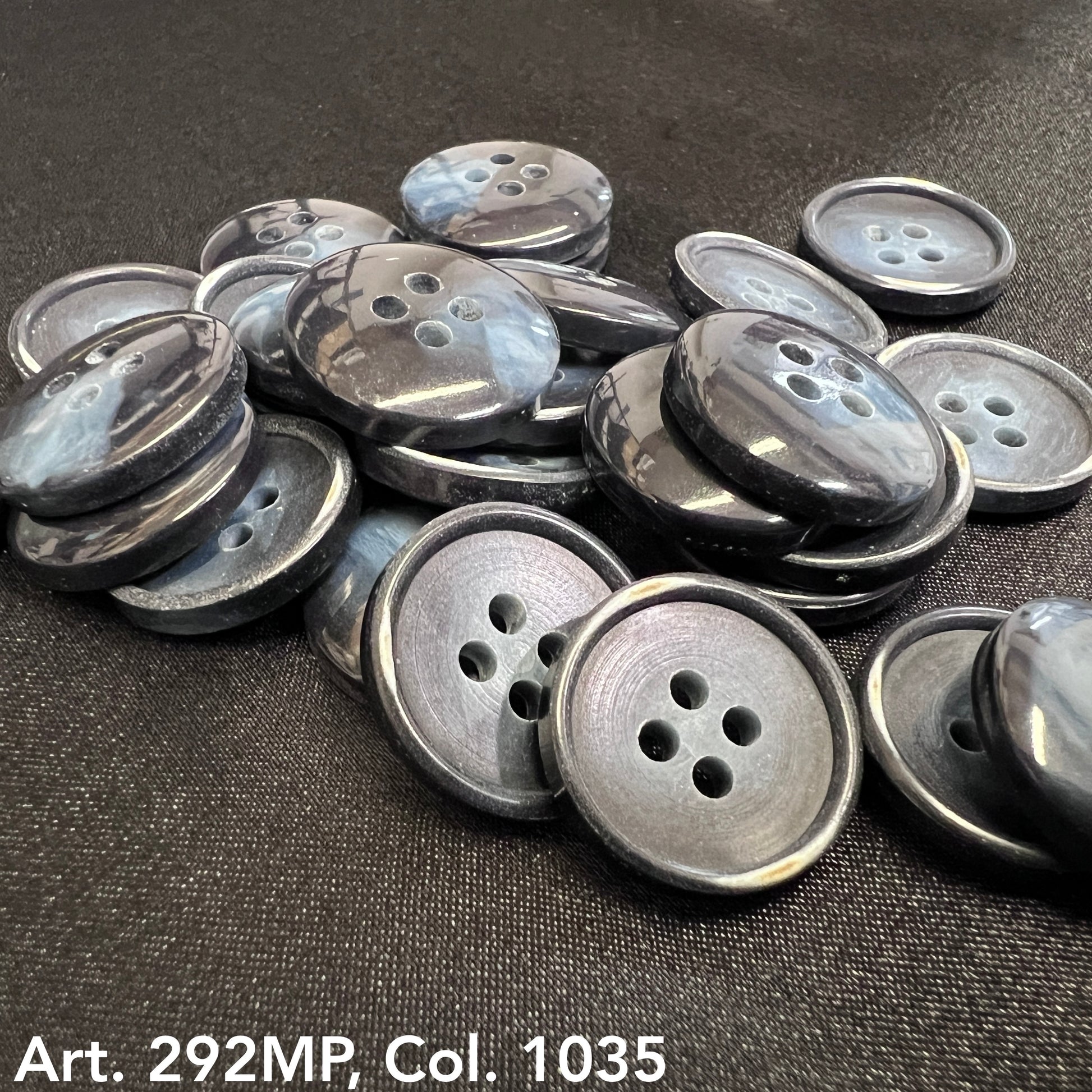 Assorted gray coat sizing buttons in various sizes from Buttonology Inc for garment alterations