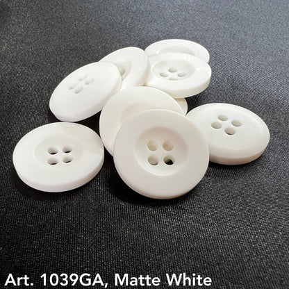 Matte white decorative buttons for sewing with four holes, arranged on a dark fabric background