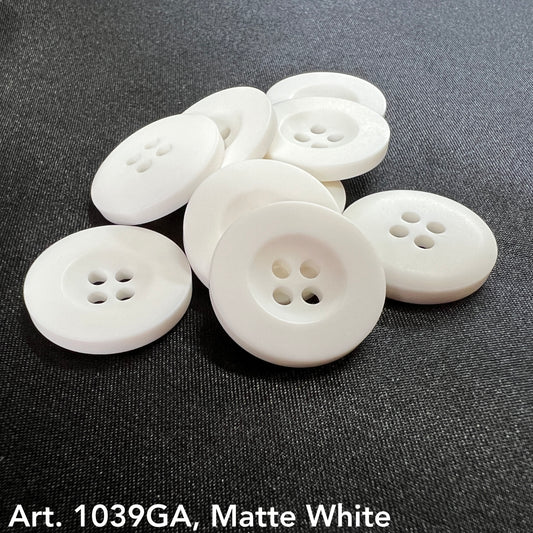 Matte white decorative buttons for sewing with four holes, arranged on a dark fabric background