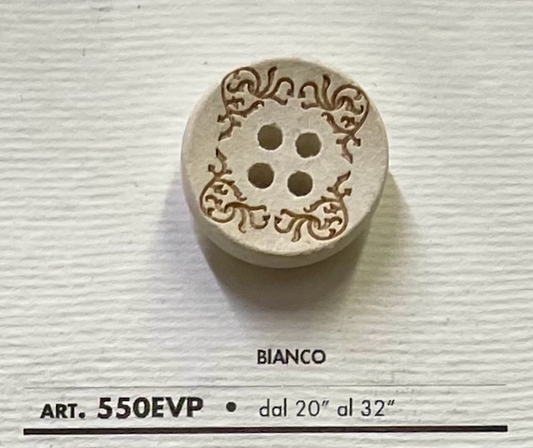 Decorative white garment button with intricate design and four holes from Buttonology Inc.