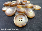 Buttonology Inc four hole sewing buttons pearlescent beige plastic buttons displayed on dark fabric