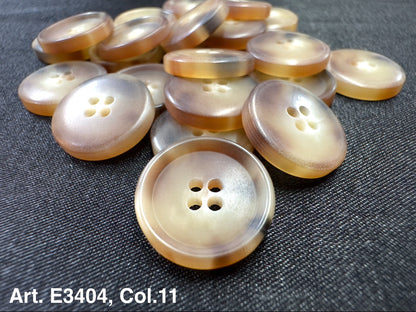 Buttonology Inc four hole sewing buttons pearlescent beige plastic buttons displayed on dark fabric