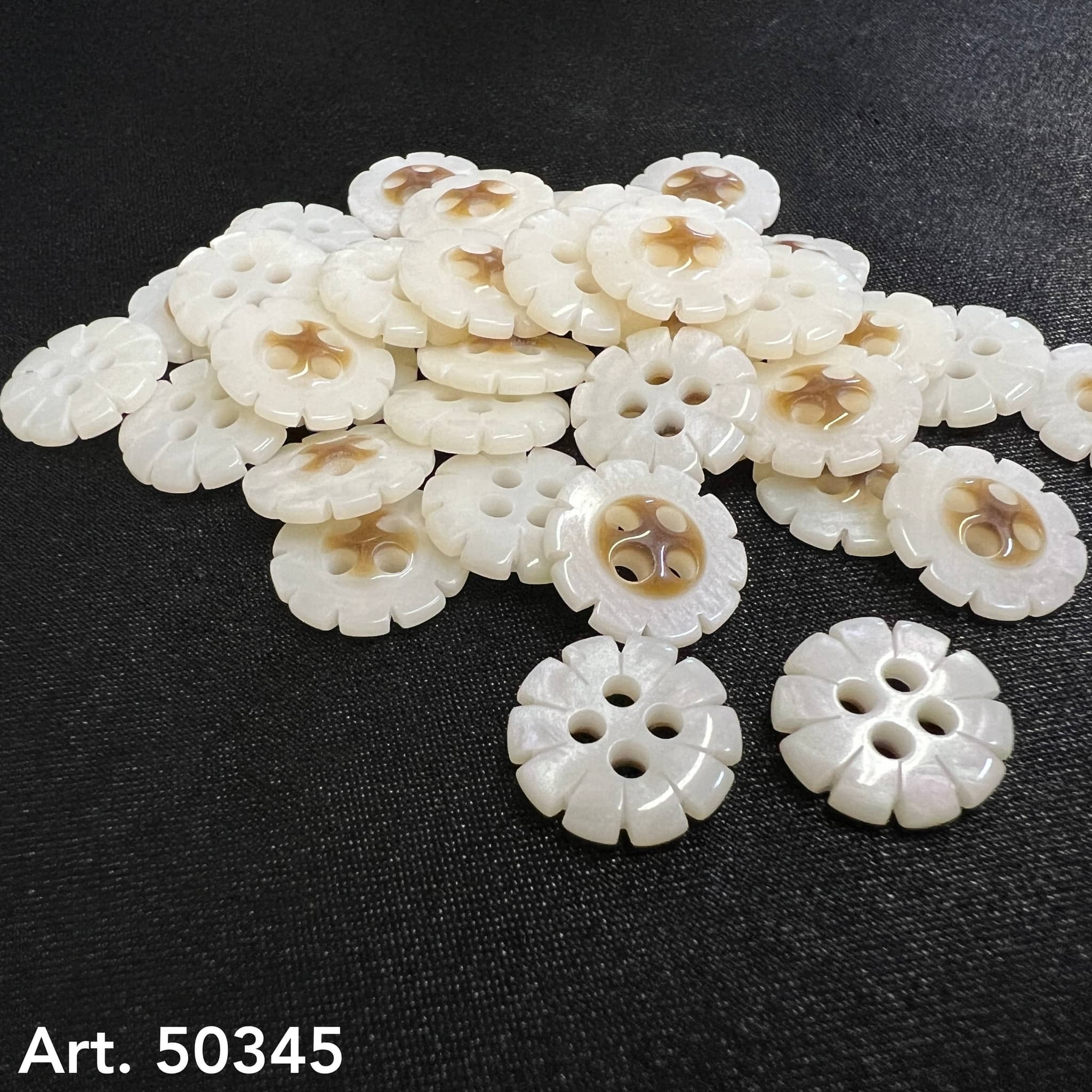 Collection of flower shape garment buttons in a creamy color from Buttonology Inc.