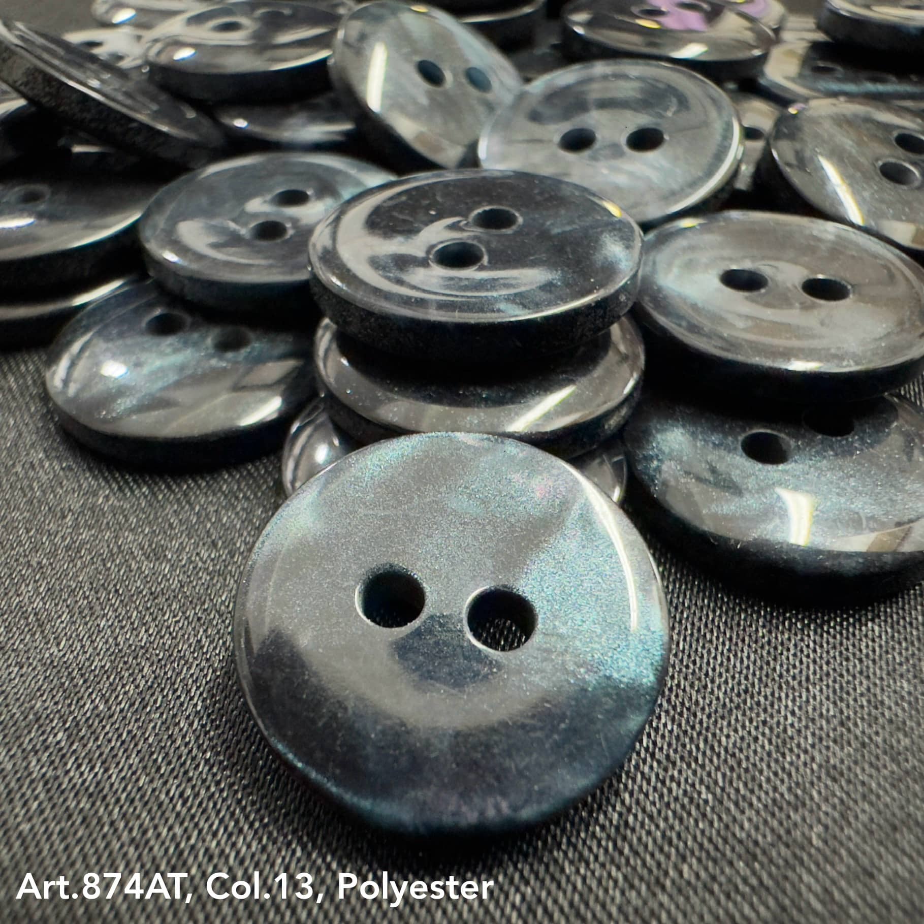 Black polyester 2-hole garment buttons bulk stacked together for sewing and crafting projects