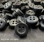 Close-up view of 18L four hole plastic buttons from Buttonology Inc. in black and gray colors