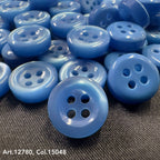 18L four hole plastic buttons in various shades of blue from Buttonology Inc on black fabric background
