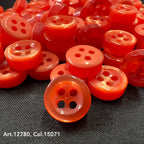 18L four hole plastic buttons in bright red stacked on black fabric by Buttonology Inc