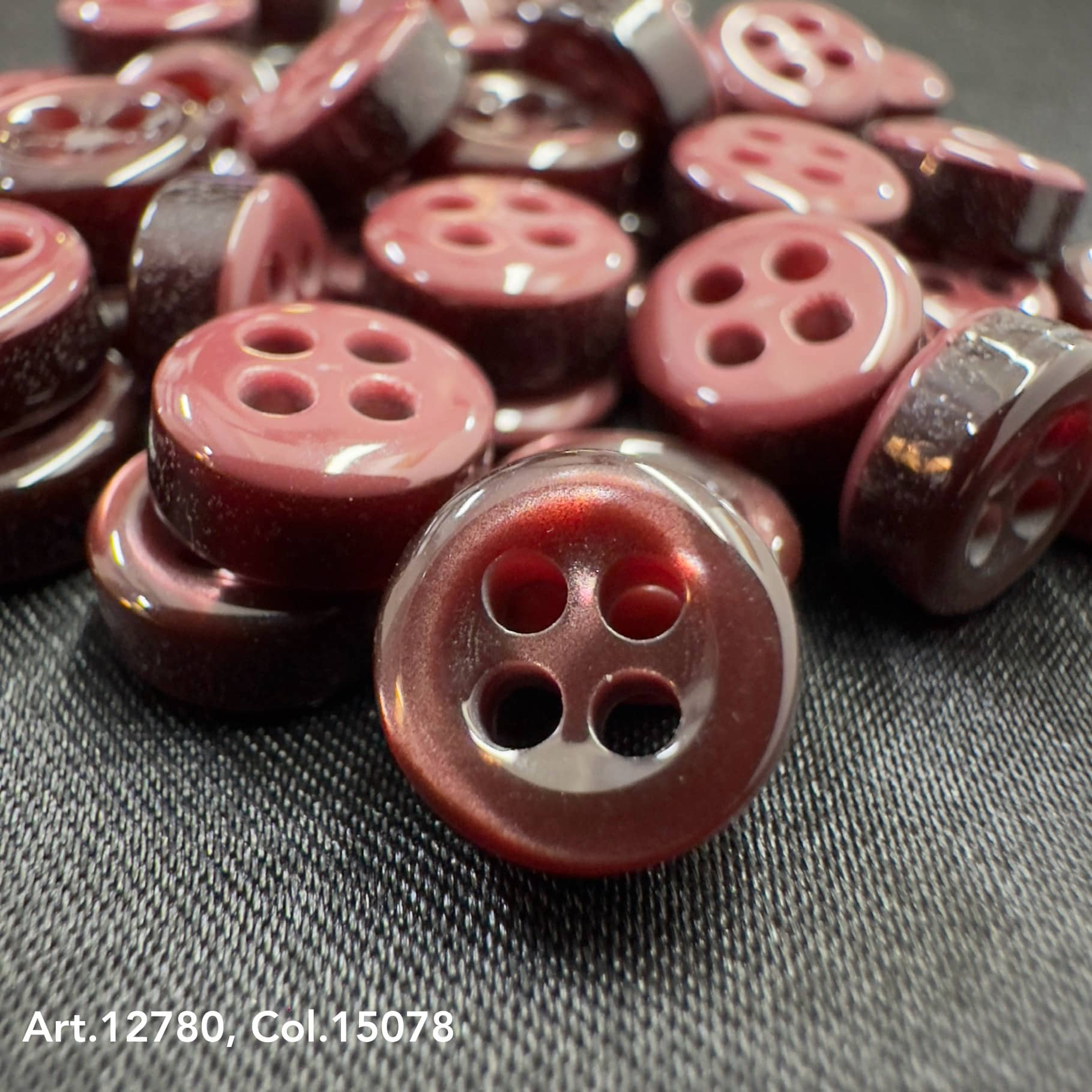 18L four hole plastic buttons in maroon color with glossy finish by Buttonology Inc