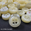 18L four hole plastic buttons in cream color by Buttonology Inc, glossy finish close-up