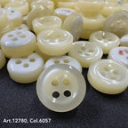 18L four hole plastic buttons in cream color by Buttonology Inc, glossy finish close-up