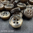 18L four hole plastic buttons in brown shade by Buttonology Inc displayed on fabric