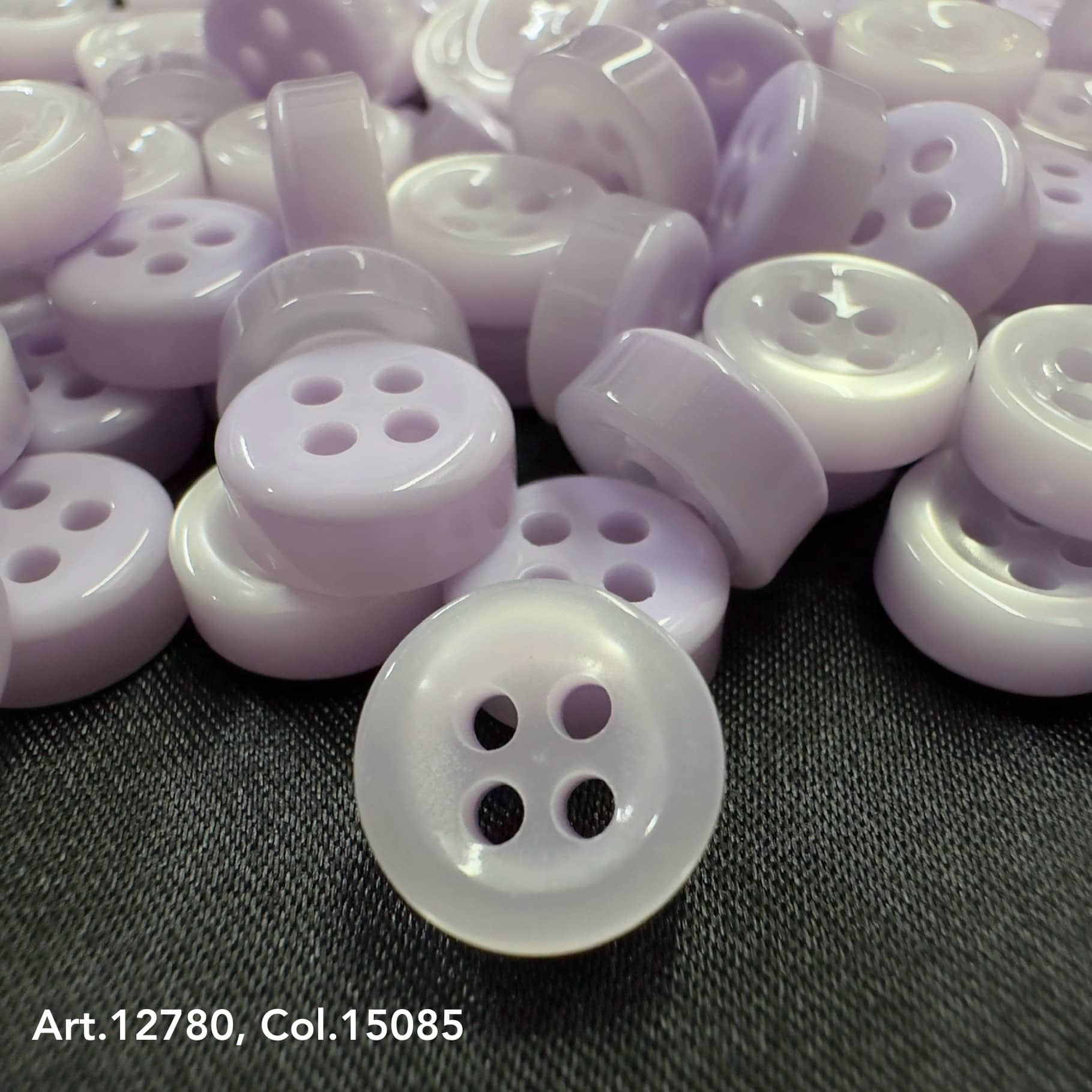 18L four hole plastic buttons in lavender color from Buttonology Inc with smooth finish