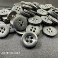 Black polyester resin sewing supplies buttons with four holes from Buttonology Inc. on fabric surface