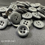 Black polyester resin sewing supplies buttons with four holes from Buttonology Inc. on fabric surface