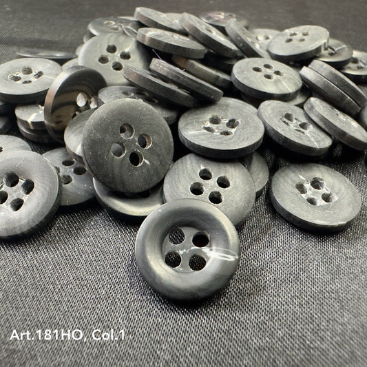 Black polyester resin sewing supplies buttons with four holes from Buttonology Inc. on fabric surface