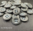 Gray buttons made from polyester resin sewing supplies by Buttonology Inc with four holes