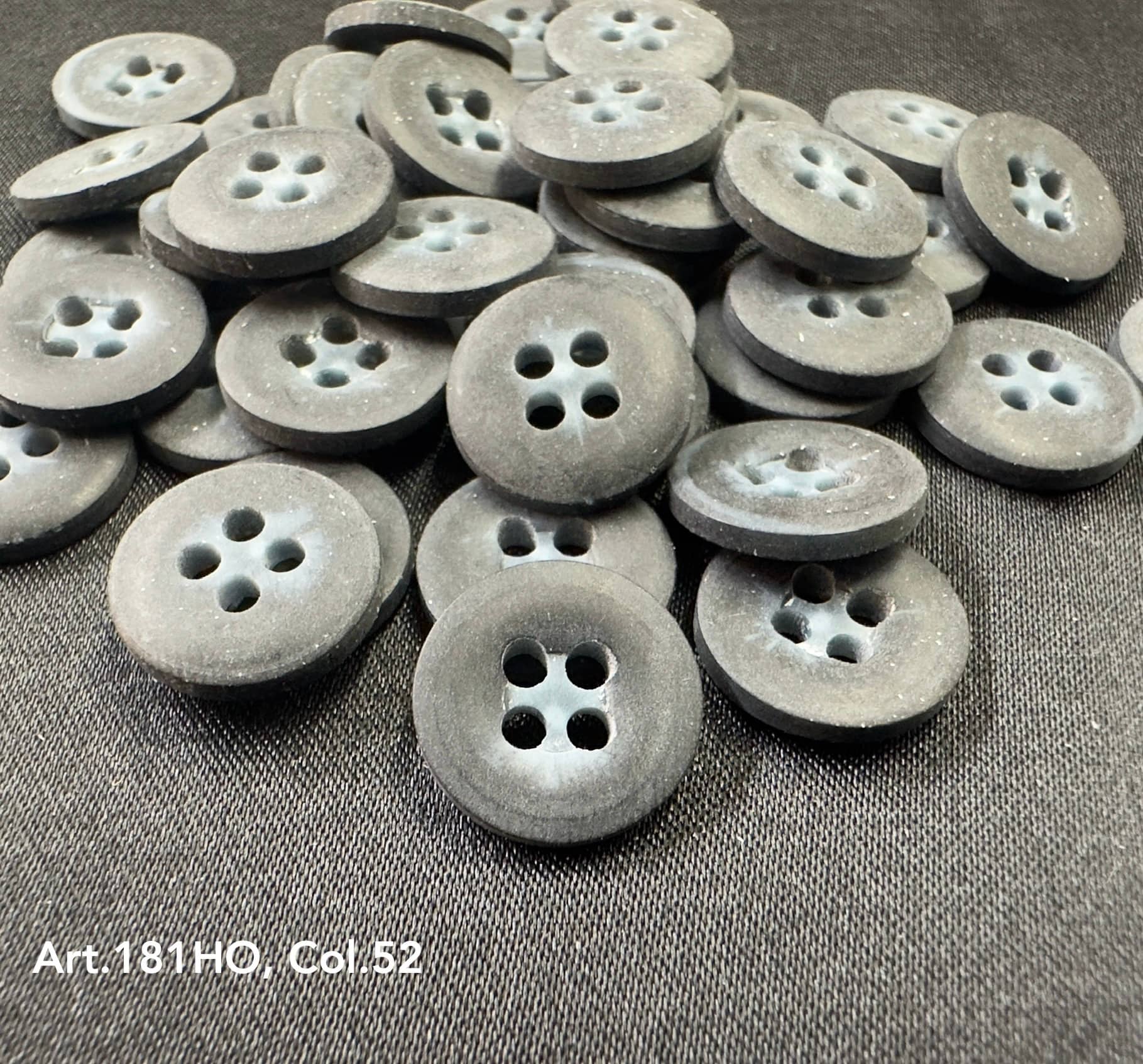 Gray buttons made from polyester resin sewing supplies by Buttonology Inc with four holes