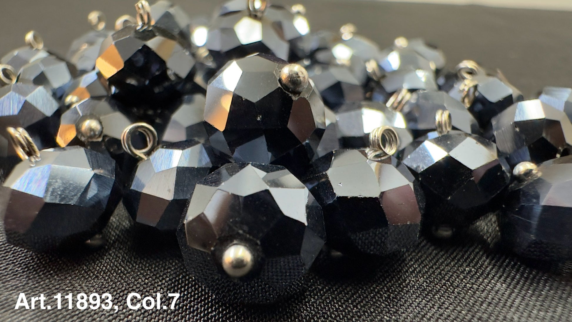 Shiny black glass buttons for sewing with a faceted design and metal loop for easy attachment