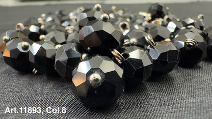 Collection of black glass buttons for sewing featuring a faceted design and shiny finish