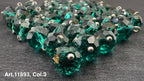Shiny green glass buttons for sewing arranged in a pile, ideal for crafting projects
