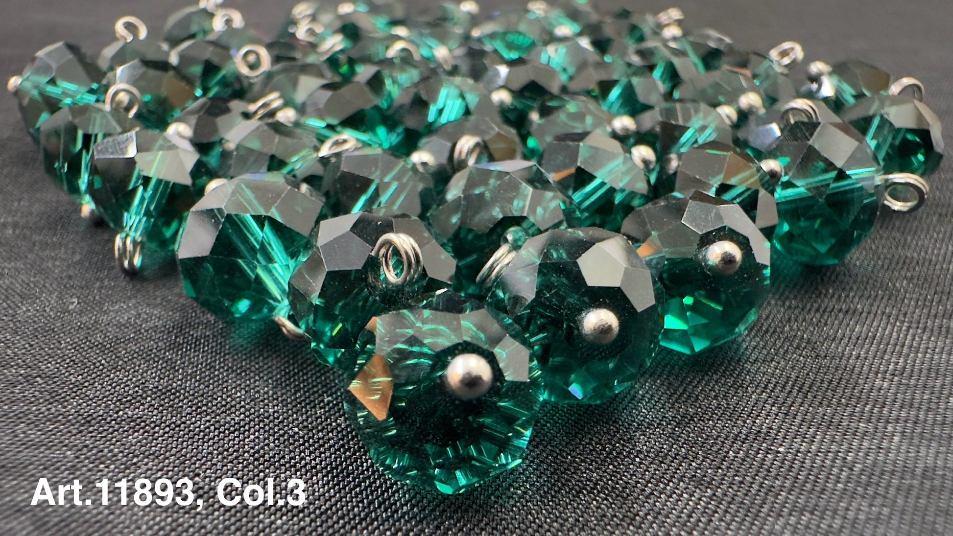 Shiny green glass buttons for sewing arranged in a pile, ideal for crafting projects