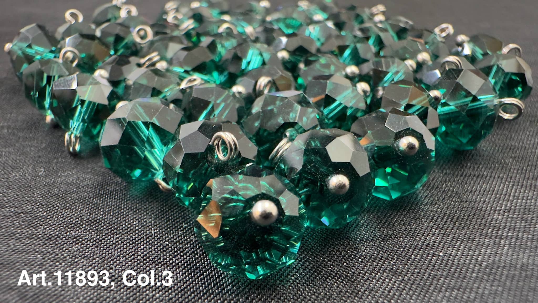 Shiny green glass buttons for sewing arranged in a pile, ideal for crafting projects