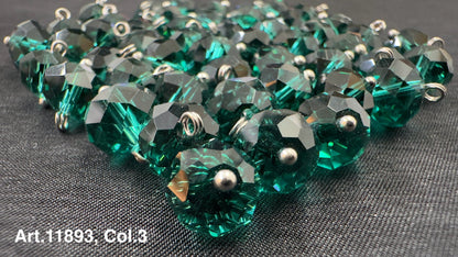 Shiny green glass buttons for sewing arranged in a pile, ideal for crafting projects