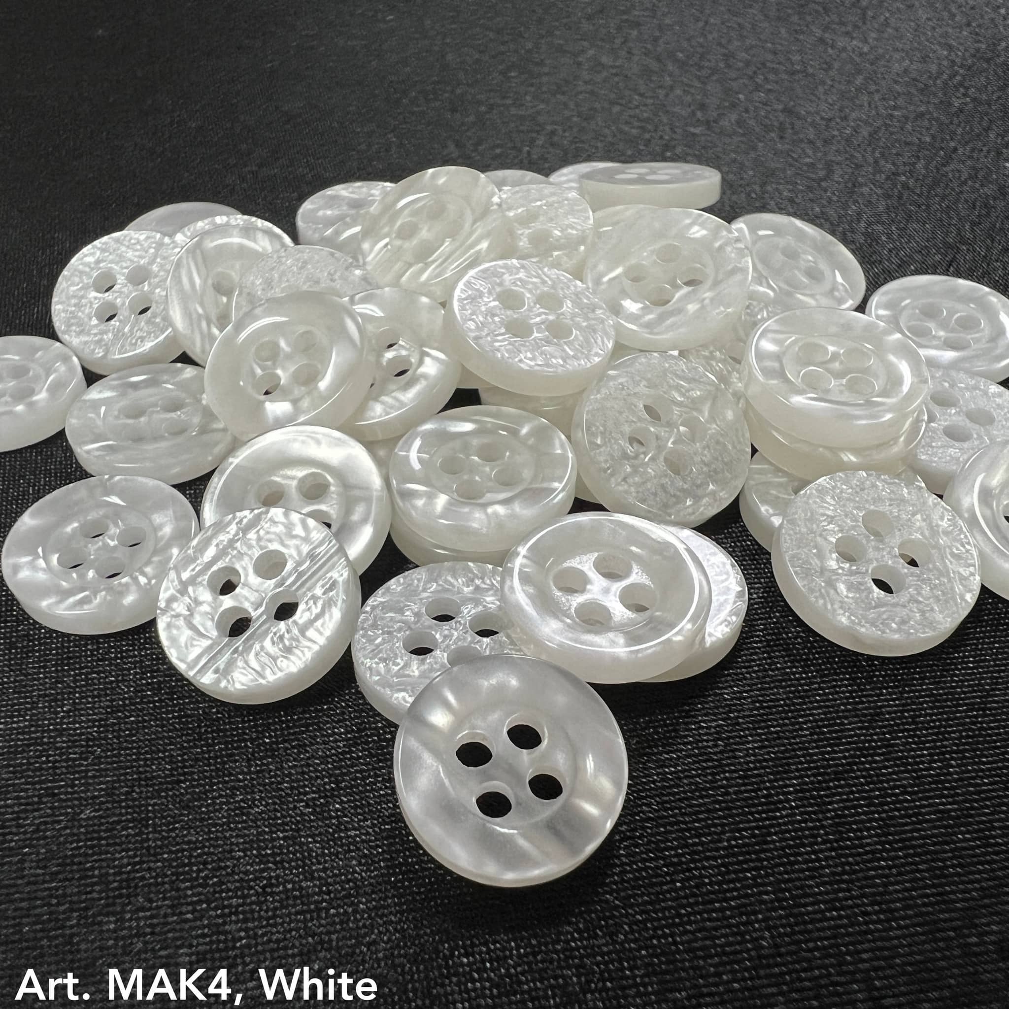 High-quality craft buttons online in white with four holes and intricate designs for custom projects
