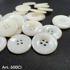 High-quality white buttons from Buttonology Inc scattered on black fabric background