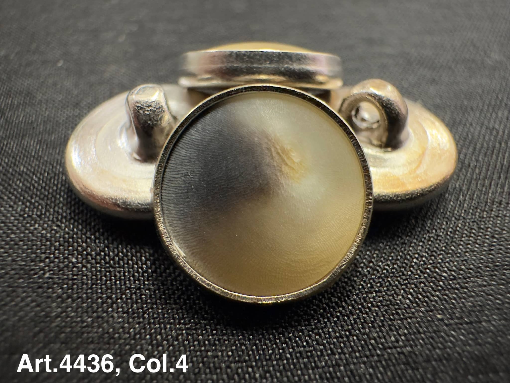 Horn shank button for coats by Buttonology Inc with a smooth shiny surface and silver tone