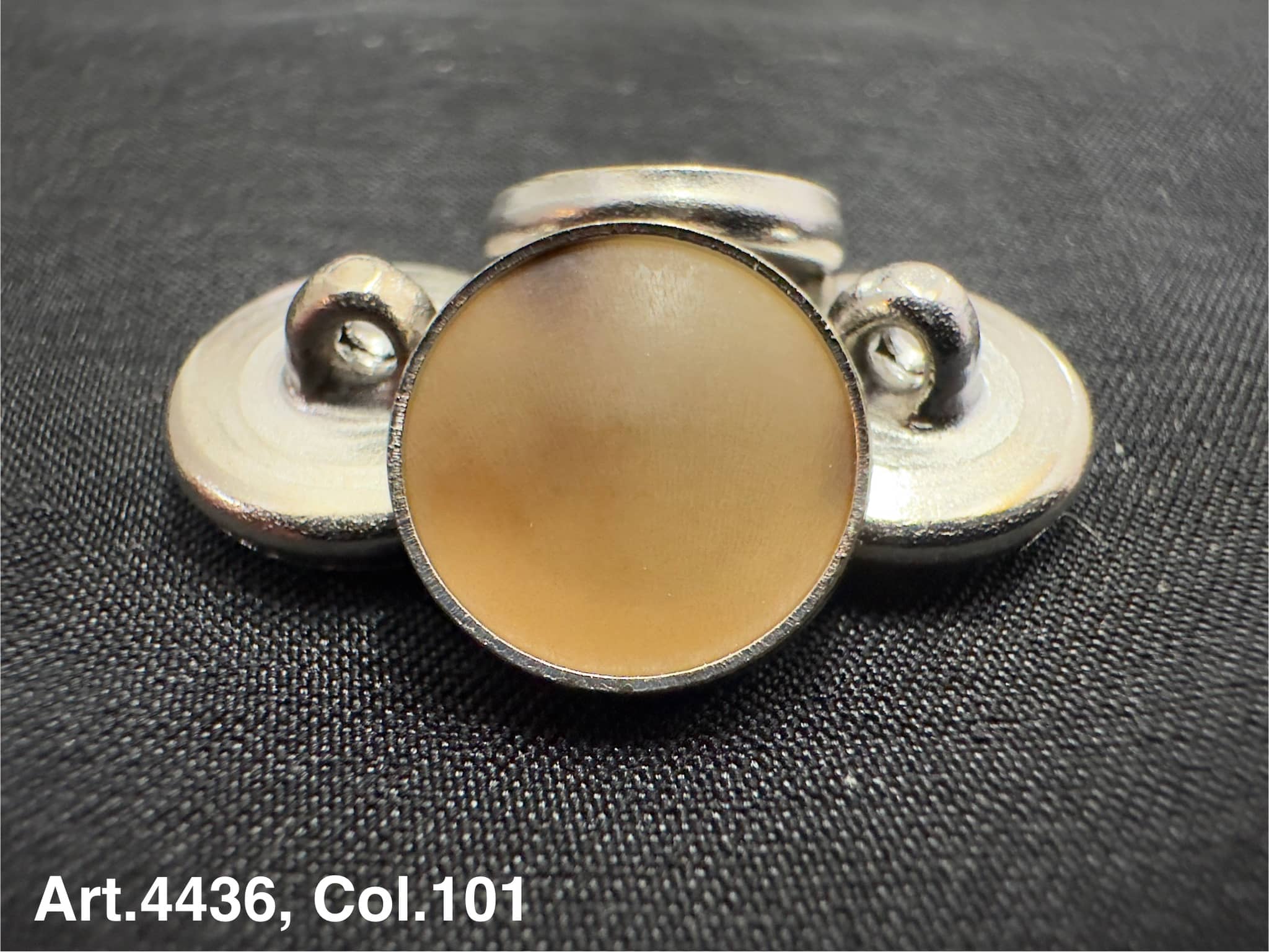 Horn shank button for coats by Buttonology Inc with round beige center and silver shank backing